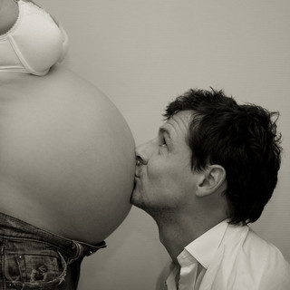Man Kissing Pregnant Woman's Belly