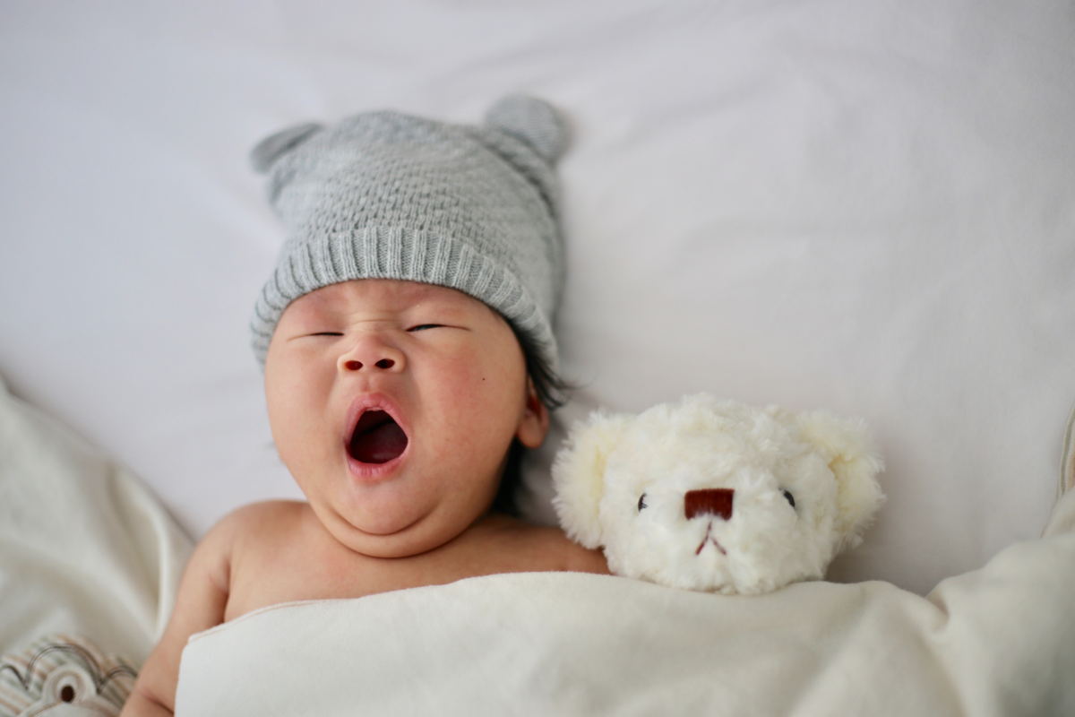 Baby Yawning in Bed