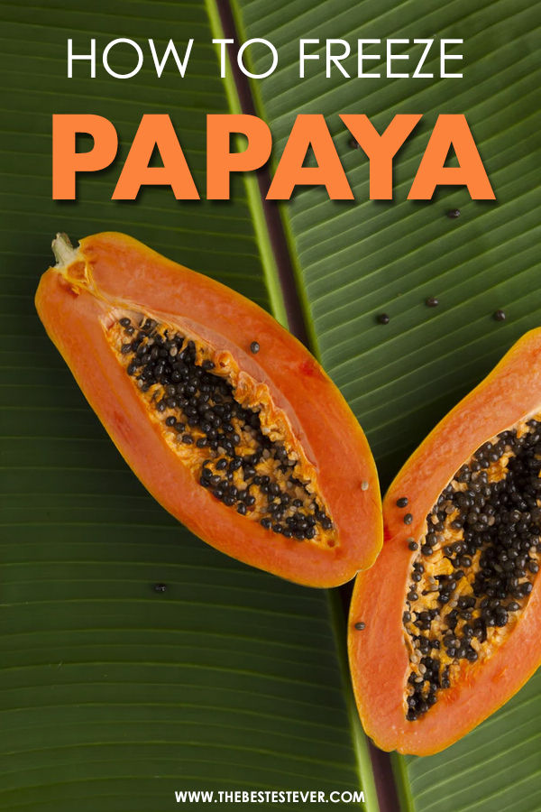 Papaya cut in two, sitting on a leaf