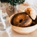 A Bagel & Croissant in a Bowl on a Table