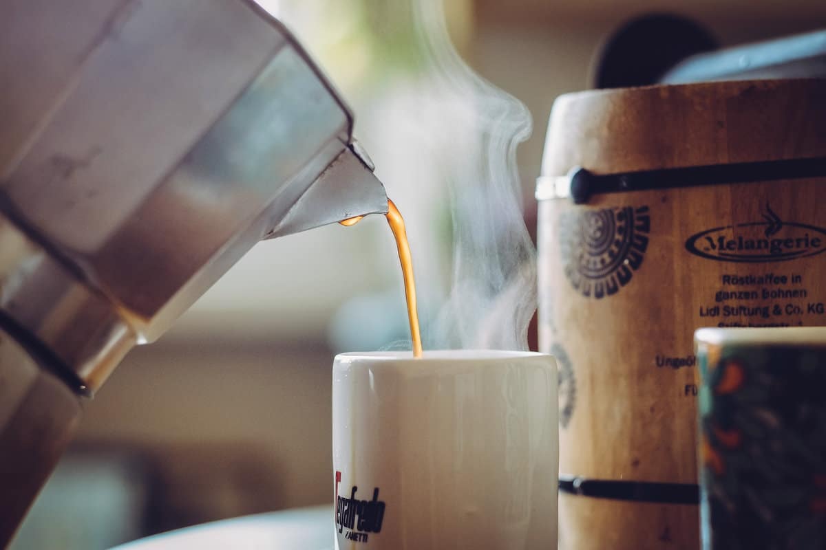 Cup of Coffee Being Poured: (Why You Should Never Reheat This Beverage)