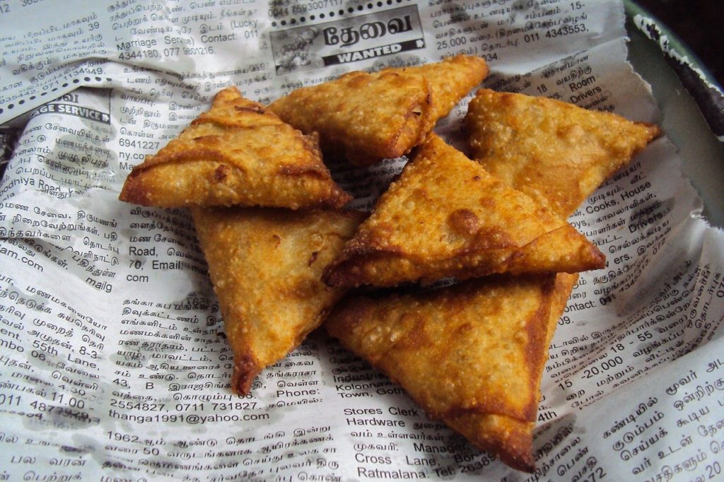 Fried Samosas Drying on Newspaper