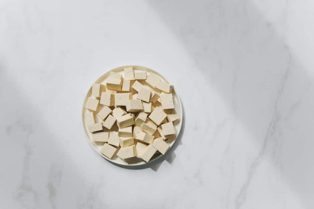 tofu in a bowl, sitting on a marble countertop