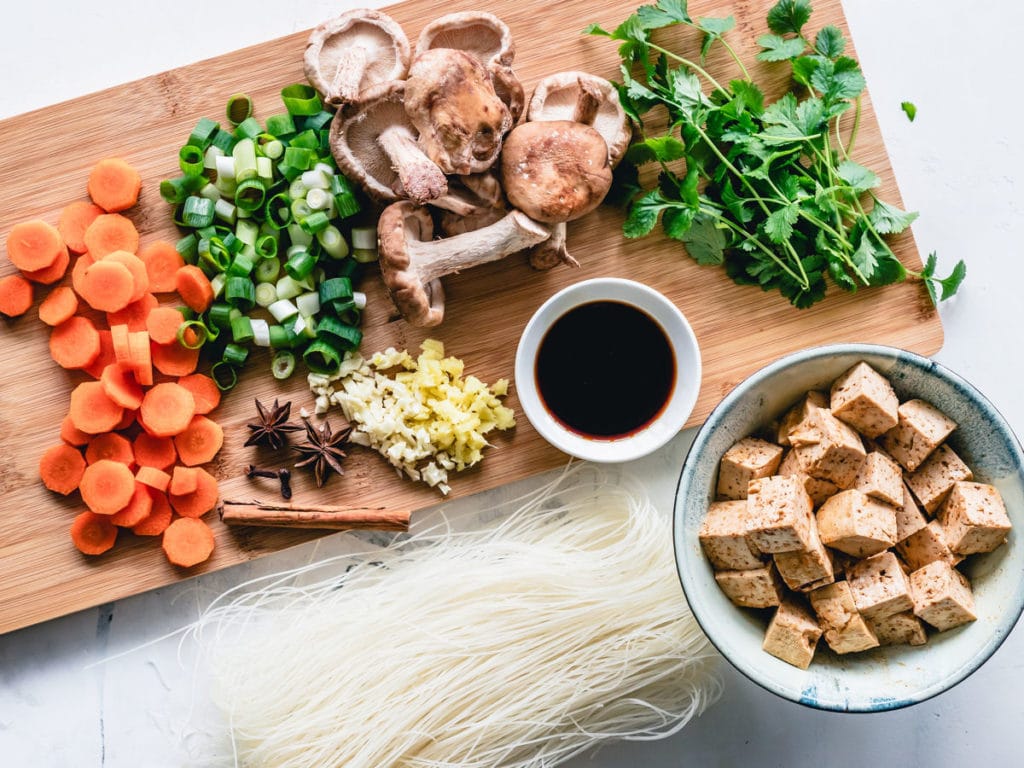 Bowl of tofu with varying ingredients being prepared to be cooked.