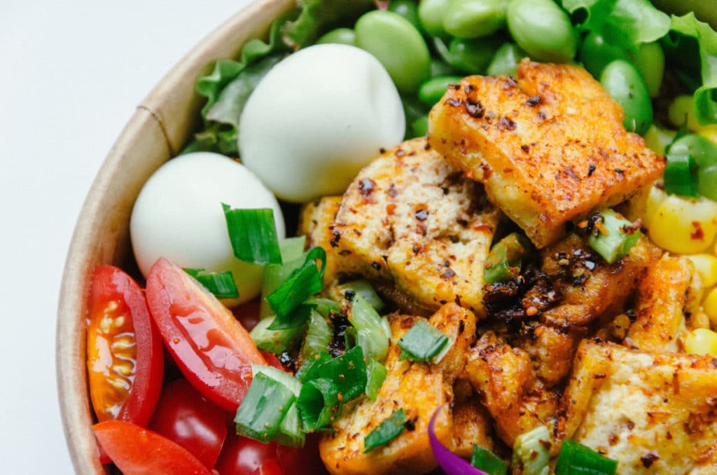 Cooked tofu in a bowl with eggs and other vegetables