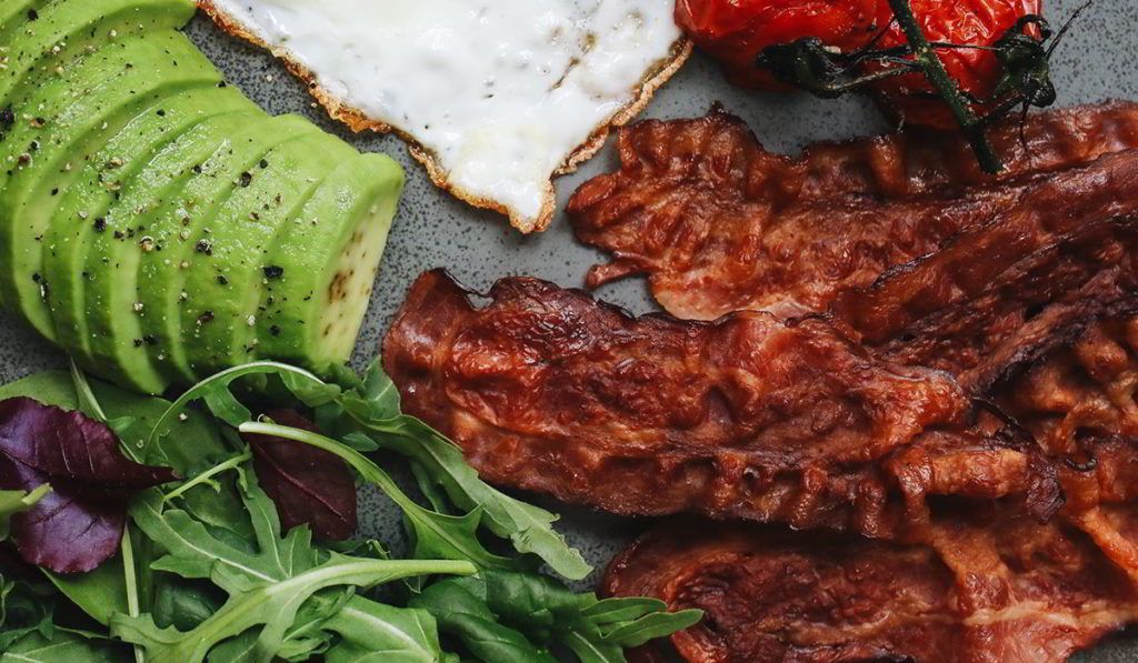 Defrosted bacon, cooking in a pan