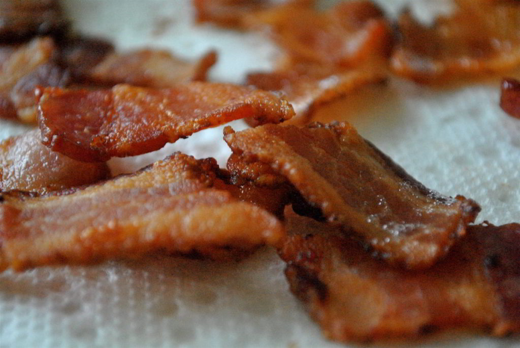 Crispy bacon cooked and sitting on a paper towel