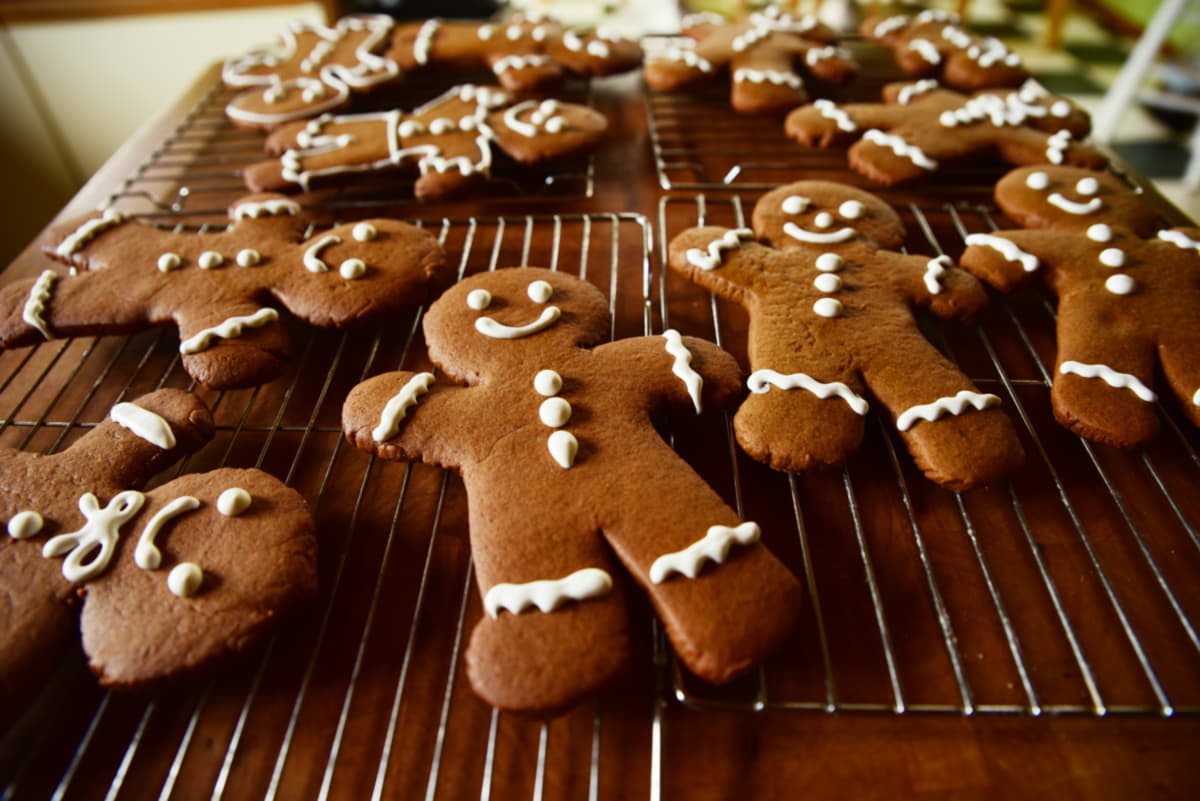 Gingerbread cut-out cookies cooling on a wire rack.