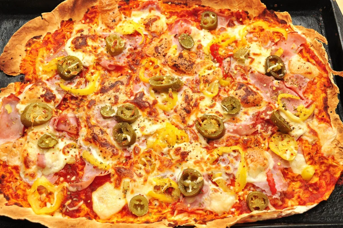 Thin lavash flatbread pizza topped with tomato sauce, mozzarella and basil