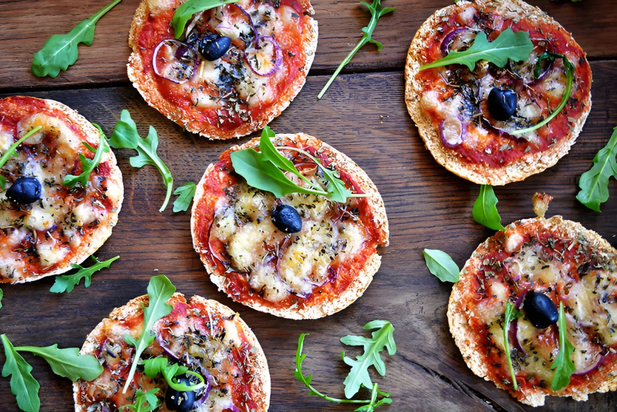 Round pita bread pizza topped with tomato sauce, melted cheese and vegetables